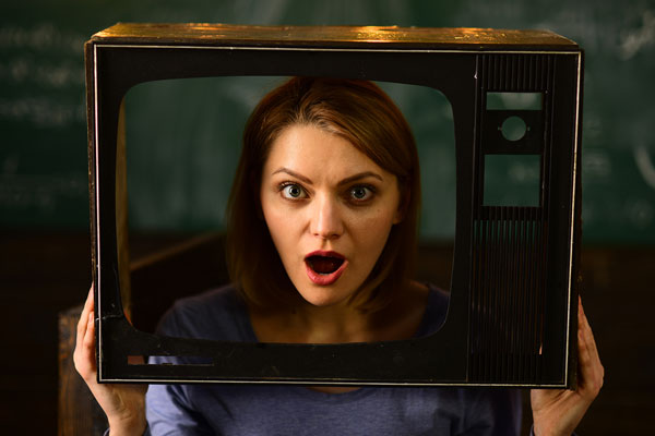 girl's face looking out of old-fashioned TV screen