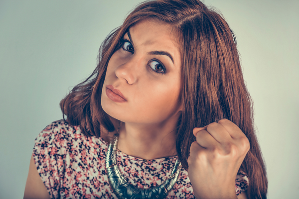 woman clenching her fist in anger